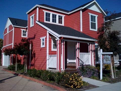 a red house with an flag on the side of it