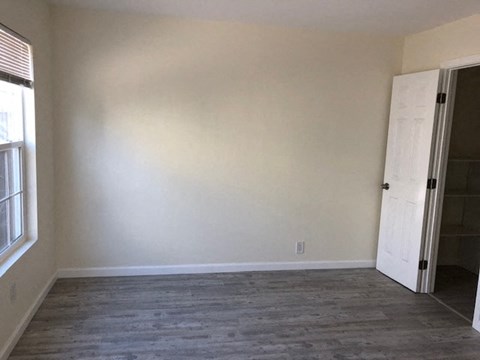 A room with a white door and a window.
