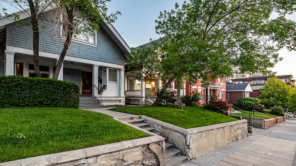 Side exterior of First Avenue Home that is blue and white