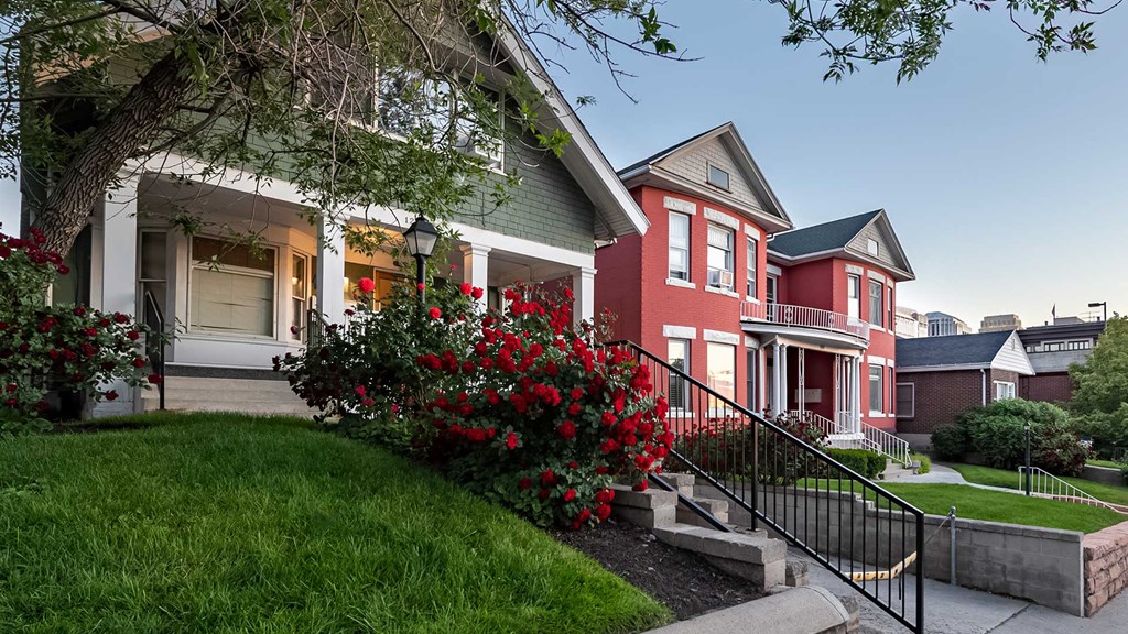 Side exterior of First Avenue Home with a rose bush