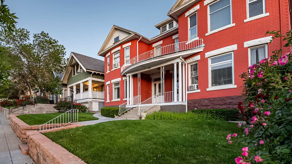 Side exterior view of red and white First Avenue Home
