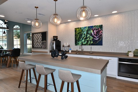 A kitchen with a counter and bar stools.