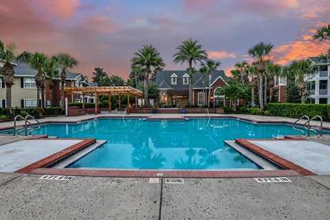 A pool surrounded by a residential area with a "NO DIVING" sign.
