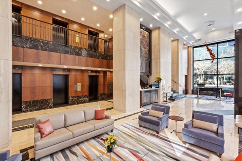 the lobby of a hotel with couches and chairs