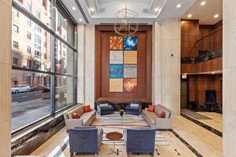 the lobby of a hotel with couches and chairs