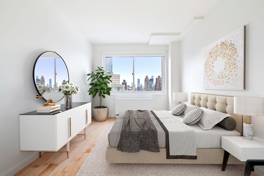 a bedroom with a large bed and a large window