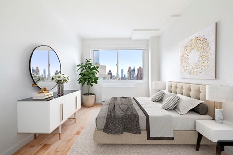 a bedroom with a large bed and a large window