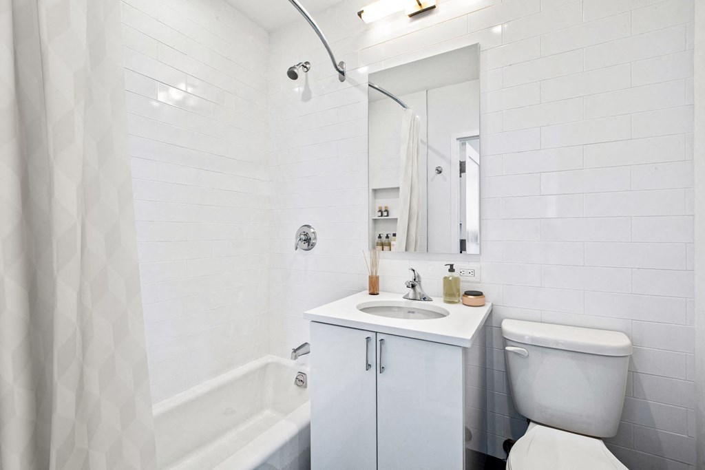 a white bathroom with a sink and a toilet