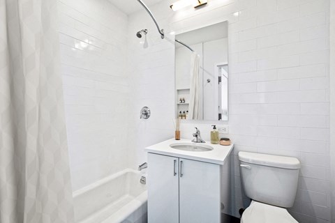 a white bathroom with a sink and a toilet