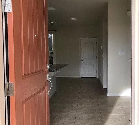 a hallway with a red door  and a white door