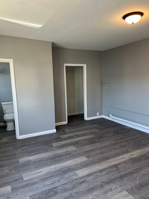 A room with a toilet and a sink.