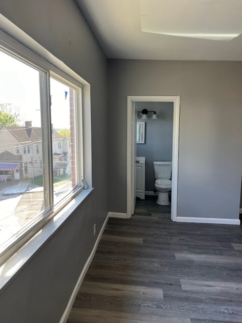 A bathroom with a toilet and sink is shown.