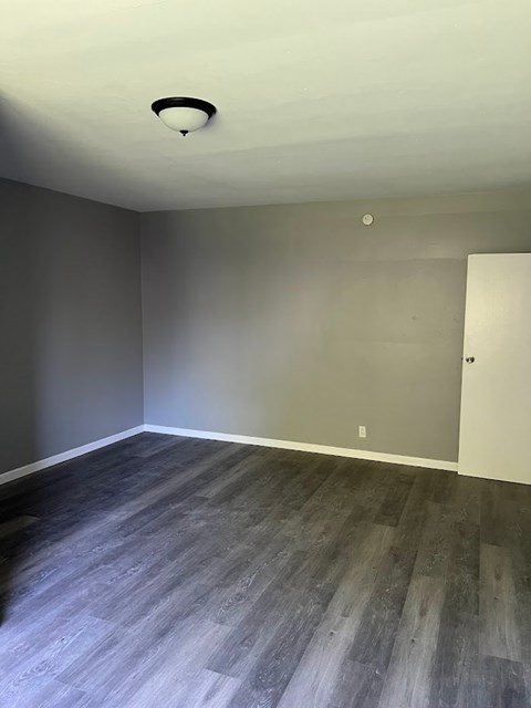A room with a grey floor and a white ceiling.