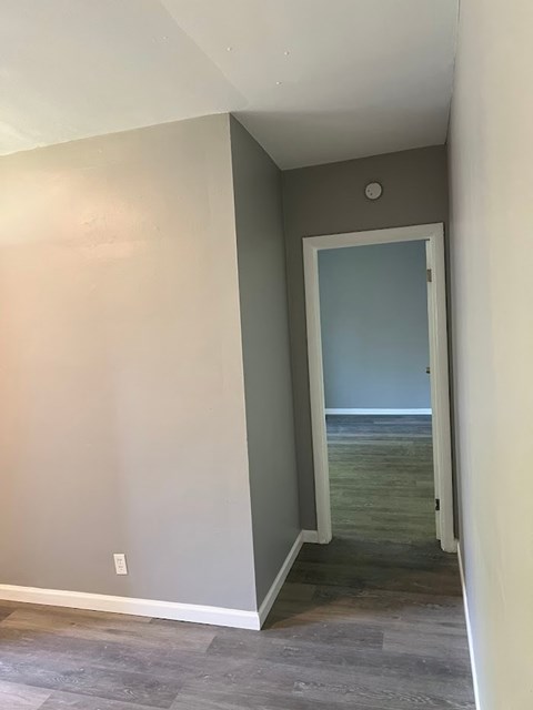 A room with a doorway leading to a hallway.