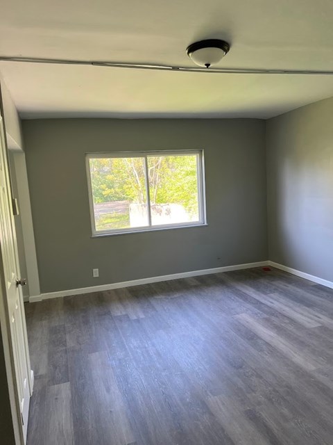 A room with a window and a ceiling fan.