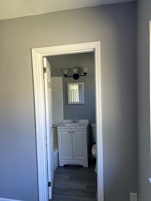 A white bathroom with a toilet and sink.