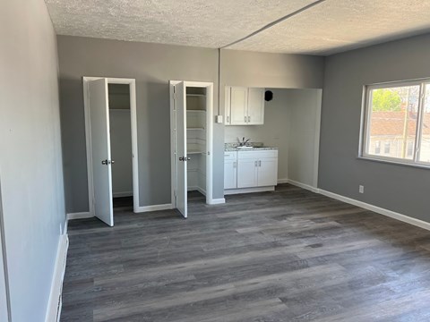 A kitchen area with a white cabinet and a sink.