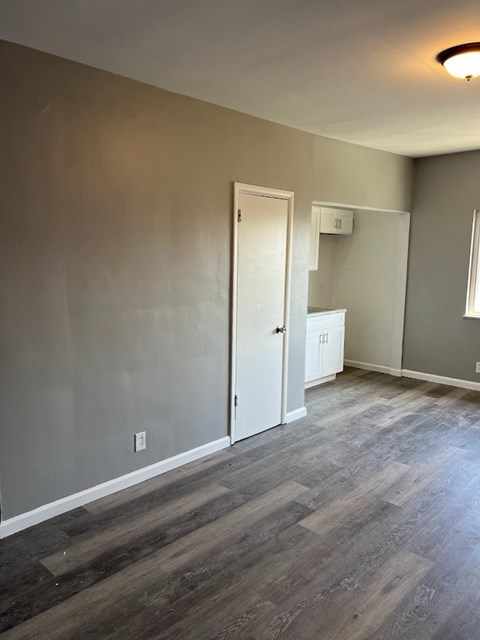 A room with a white door and a white cabinet.