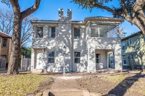 an old with trees in front of it