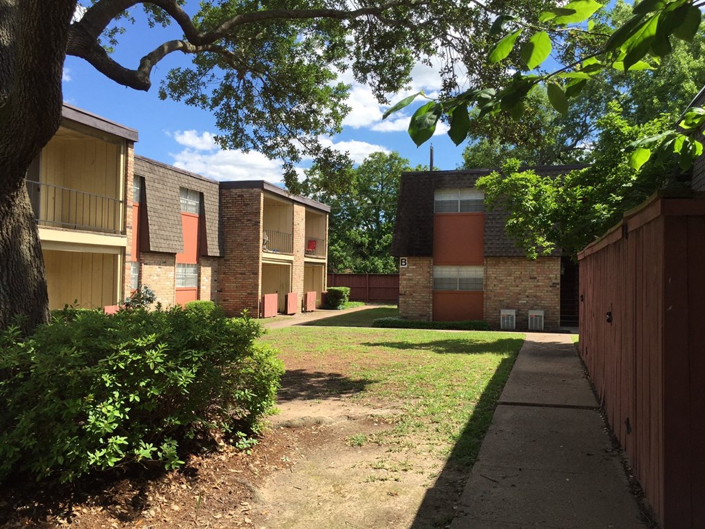 a row of brick apartment buildings with a sidewalk