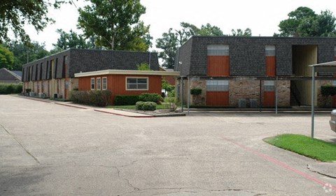 an empty parking lot in front of a building