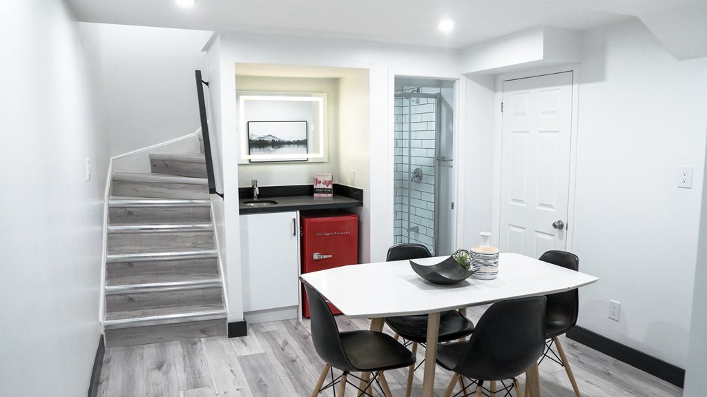 A dining room with a table and chairs.