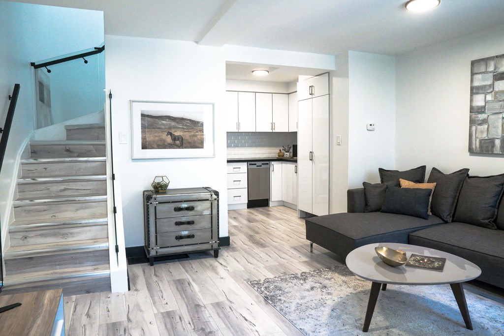 A living room with a grey couch and a coffee table.
