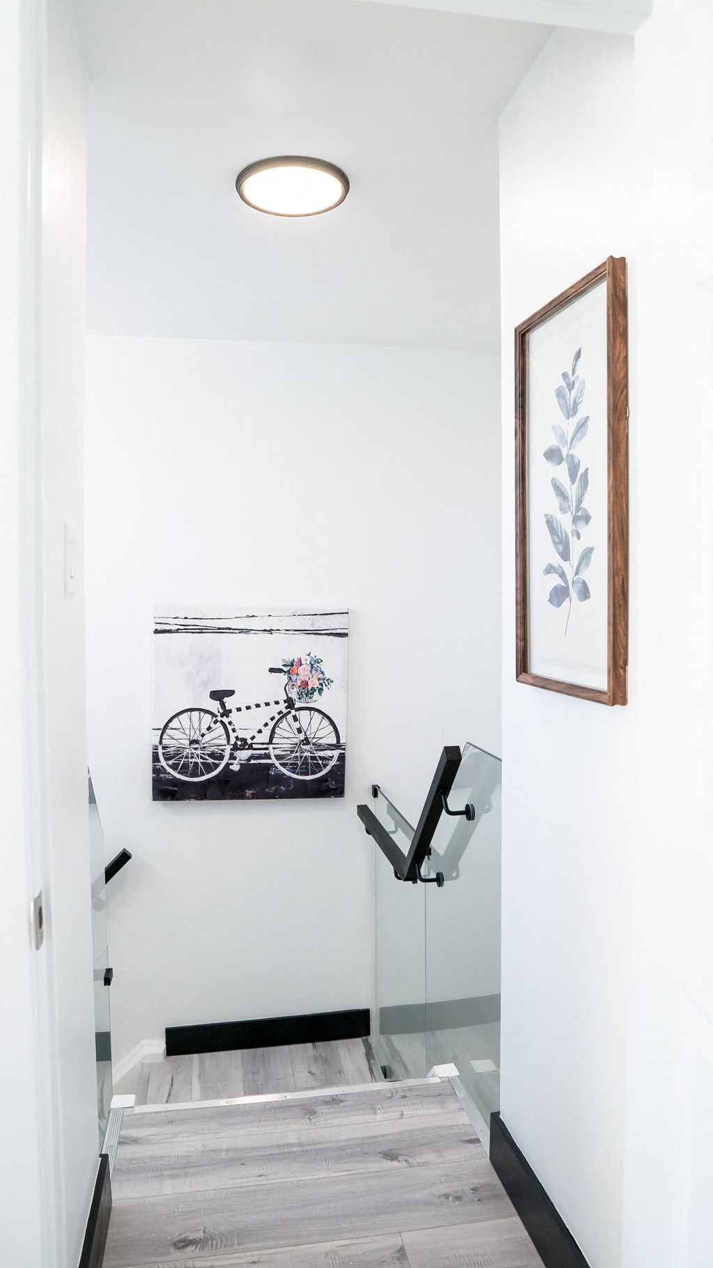 A hallway with a bicycle picture on the wall.