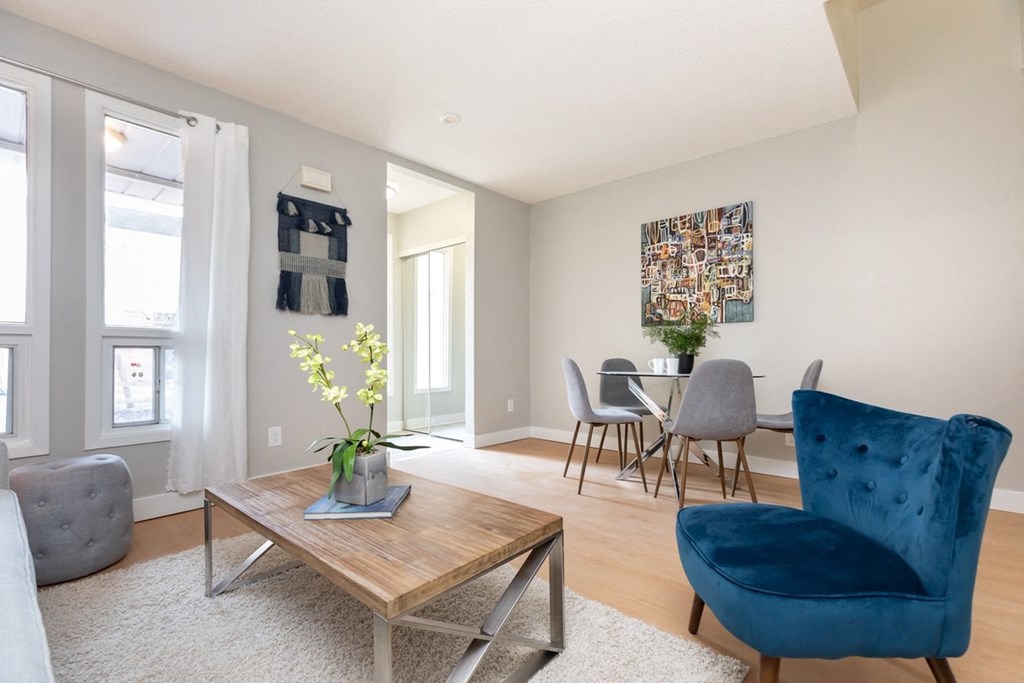 A living room with a blue chair and a coffee table.