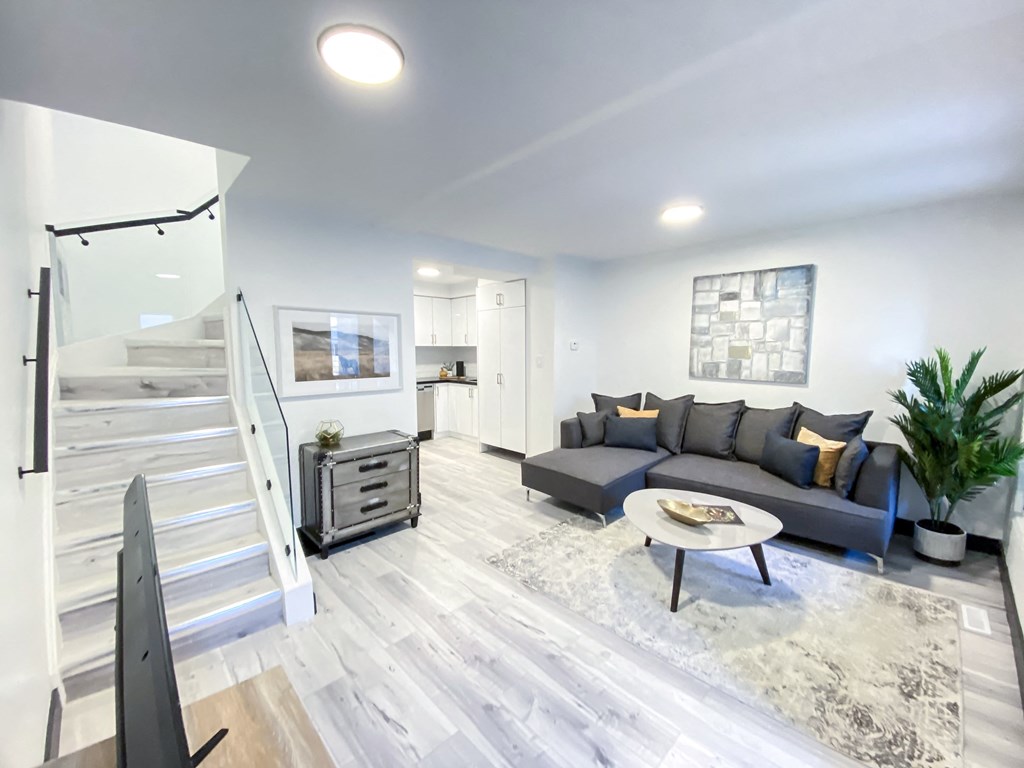 A modern living room with a grey sofa and a coffee table.