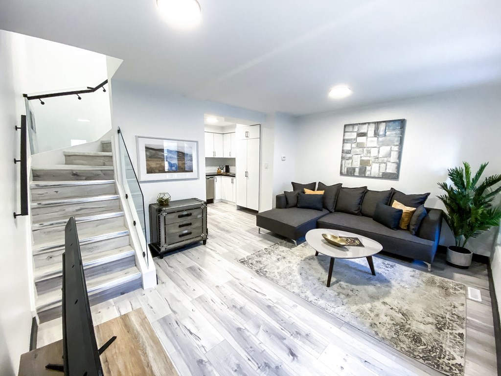 A modern living room with a grey sofa and a coffee table.