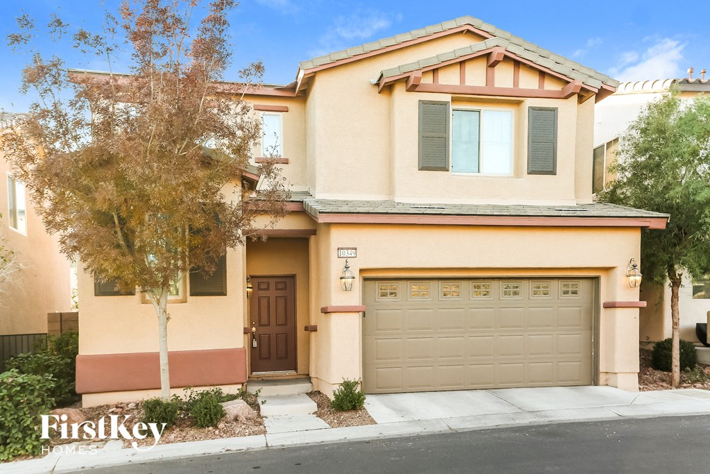 A two-story house with a brown door and a garage door.