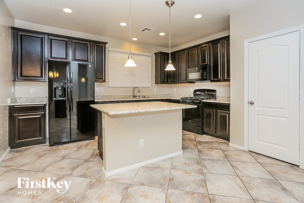 A kitchen with a large island in the middle.
