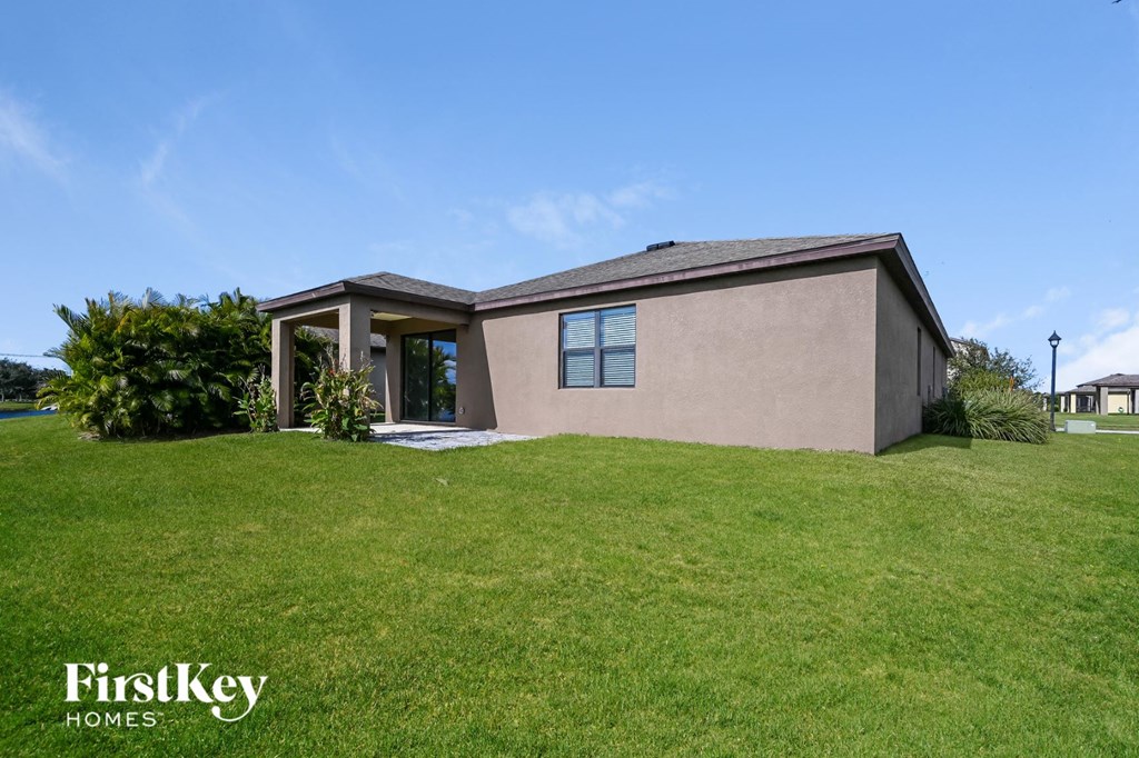 a small house with a grassy yard and a roof