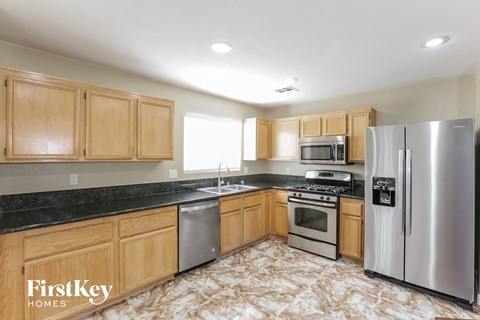 a kitchen with wooden cabinets and stainless steel appliances
