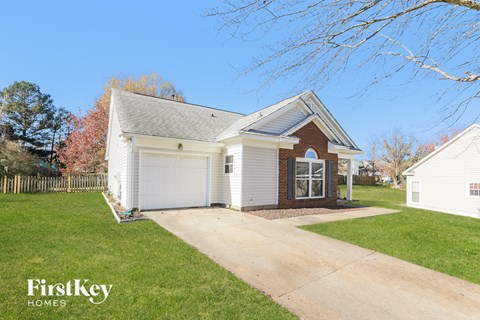 a white house with a driveway and a garage door