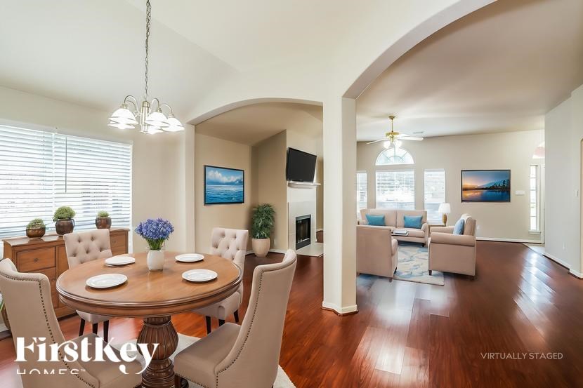 A dining room with a wooden table and chairs.