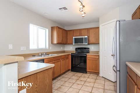A kitchen with wooden cabinets and a white refrigerator.