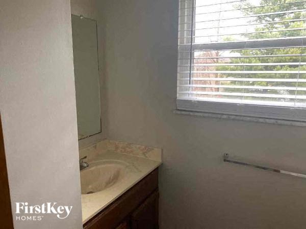 A bathroom with a sink and a window.