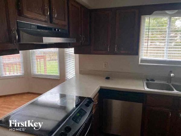 A kitchen with a stove top oven and a dishwasher.