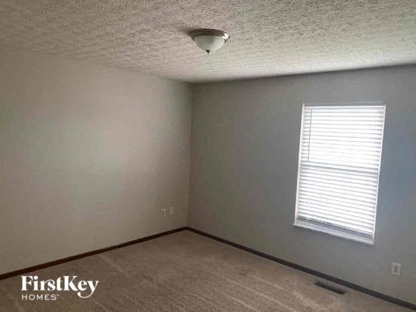 A room with a FirstKey Homes logo on the bottom left corner.