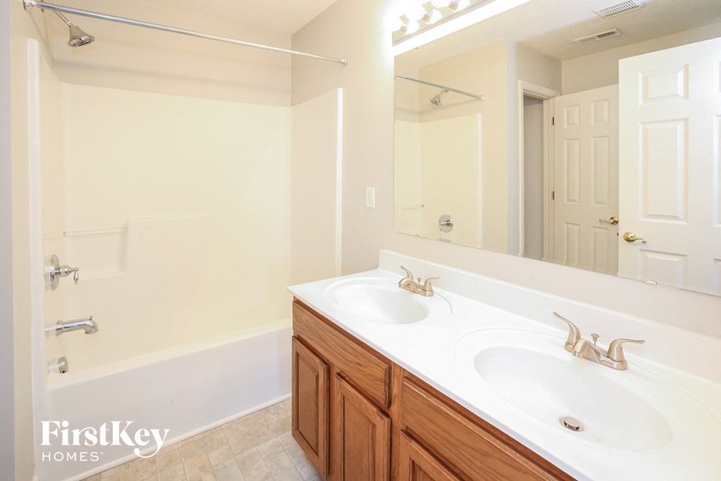 a bathroom with two sinks and a large mirror