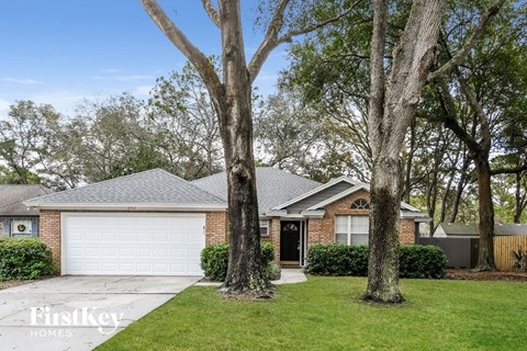 a house with two trees in front of it