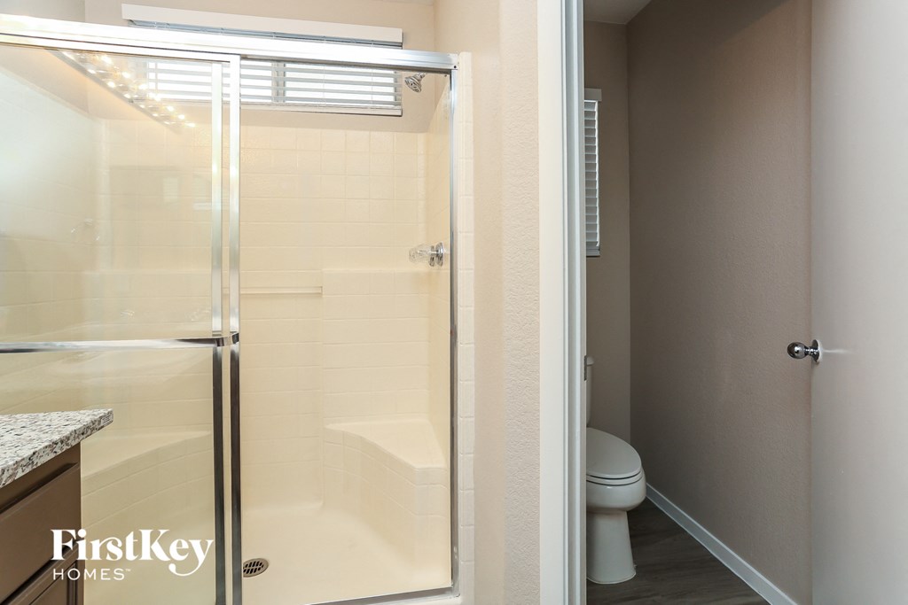 a bathroom with a shower and a toilet in it