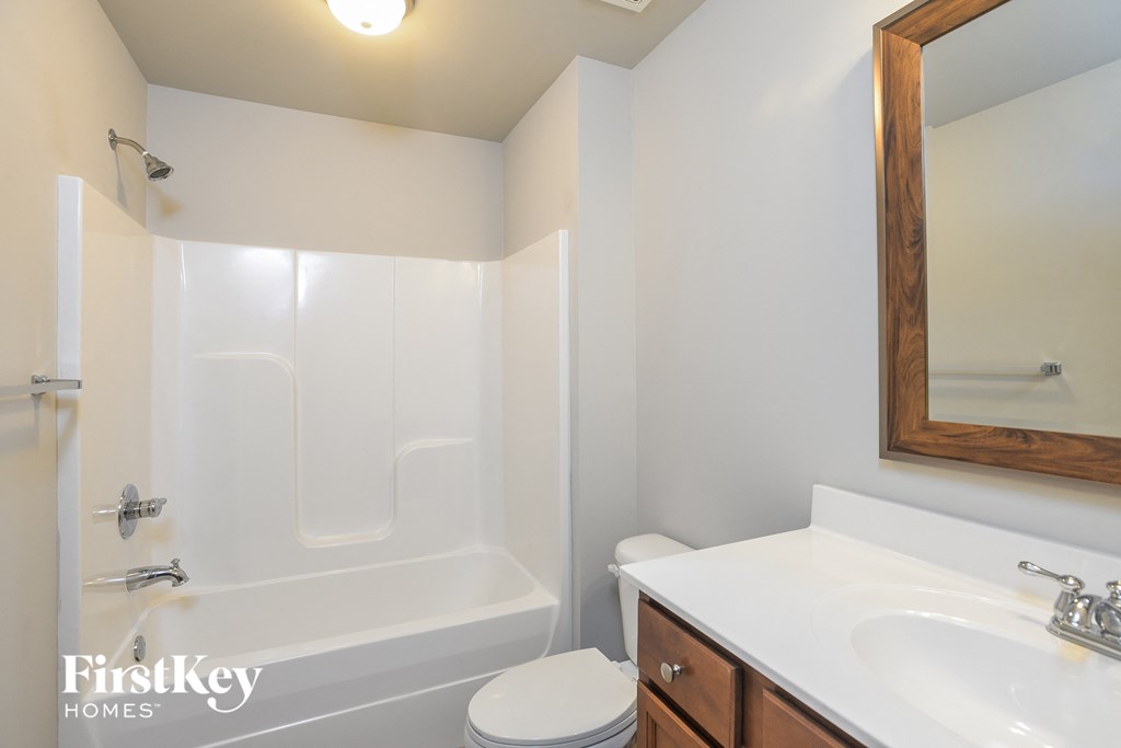 a bathroom with a white sink and a toilet and a bath tub