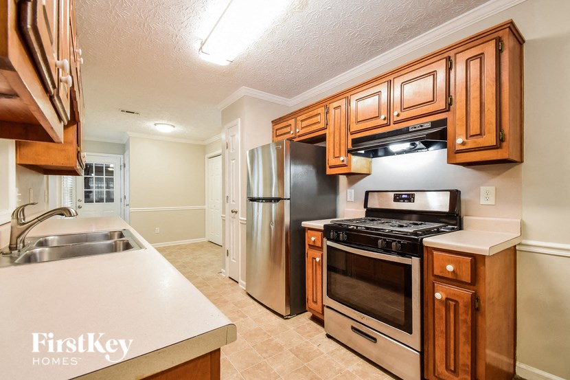 a kitchen with stainless steel appliances and wooden cabinets