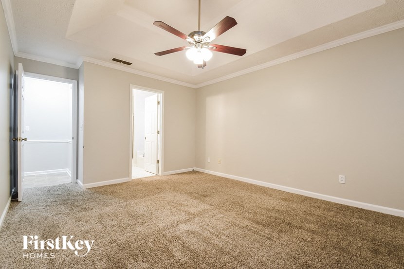 a empty living room with a ceiling fan