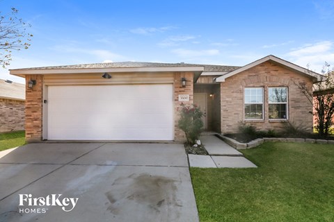 A house with a garage door and a sign that says "FirstKey Homes".