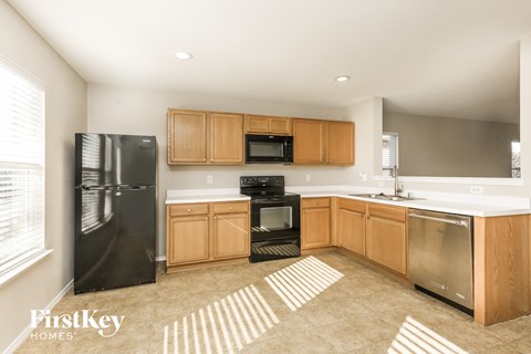 A kitchen with wooden cabinets and stainless steel appliances.