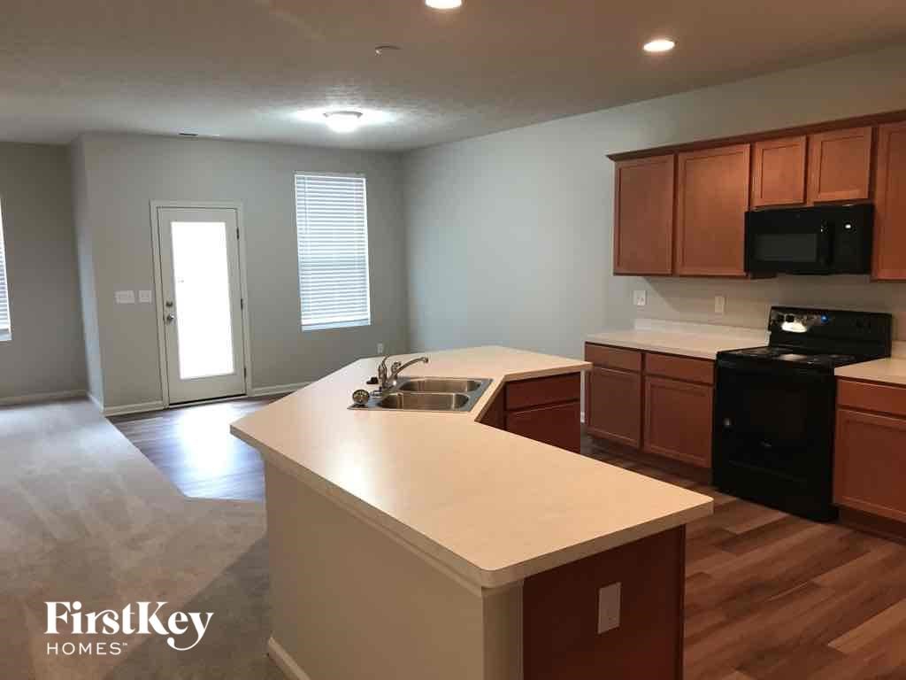 A kitchen with wooden cabinets and a white countertop.